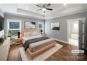 Serene bedroom featuring tray ceilings, hardwood floors, two windows and neutral decor at 1210 Aragon Beach Rd, Rock Hill, SC 29732