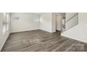 Bright living room featuring modern flooring, neutral walls, and staircase access at 138 Aberdeen Dr, Salisbury, NC 28144