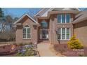 Detailed front entry features lush landscaping and attractive brick facade at 143 Shoreview Dr # 7, Mooresville, NC 28117