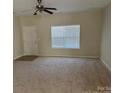 Bright living room with neutral paint, ceiling fan, and carpeted floors at 15200 Chowning Tavern Ln, Charlotte, NC 28262