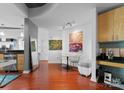 Open floor plan showcasing kitchen and living area with hardwood flooring at 210 N Church St # 2409, Charlotte, NC 28202