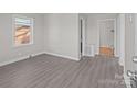 Bright bedroom featuring hardwood floors, neutral walls, and ample natural light from large window at 2640 Olando St, Charlotte, NC 28206