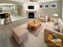 Bright living room with fireplace, plush seating, and open layout to the kitchen at 2702 Occaneechi Ct, Waxhaw, NC 28173