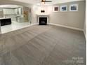 Spacious living room with a fireplace and open layout, ready for your personal touch at 2702 Occaneechi Ct, Waxhaw, NC 28173