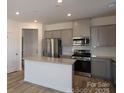 Bright kitchen features stainless steel appliances and gray cabinets at 4005 Lawnview Dr, Charlotte, NC 28269