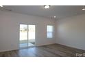 Open-concept living room with sliding glass door for ample natural light and outdoor access at 4005 Lawnview Dr, Charlotte, NC 28269