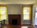 Cozy living room features a brick fireplace and sunny windows, creating a warm atmosphere at 441 Hope St, Rock Hill, SC 29730