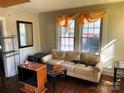 Bright living room featuring a comfortable sofa and natural light from large windows at 441 Hope St, Rock Hill, SC 29730