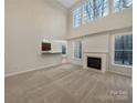 Spacious living room with tall windows and a fireplace at 5002 Fine Robe Dr, Indian Trail, NC 28079