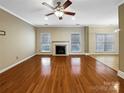 Spacious living room with hardwood floors, a fireplace, recessed lights, and natural light from the windows at 621 Ravenglass Dr, Fort Mill, SC 29715