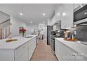 Bright, open kitchen featuring white cabinets, stainless steel appliances, and an island with sink at 6278 Ashton Park Dr, Denver, NC 28037