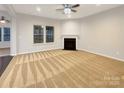 Bright living room with a cozy fireplace and large windows for natural light at 705 Old Cove Rd, Tega Cay, SC 29708