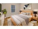 Stylishly staged bedroom with neutral tones, featuring a large window and contemporary artwork at 705 Old Cove Rd, Tega Cay, SC 29708