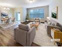 Bright living room with hardwood floors, large windows, and stylish neutral decor at 8619 Harris Lake Ln, Charlotte, NC 28269