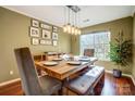 Well-lit dining room showcasing a rustic wood table and modern pendant lighting at 9220 Torrence Crossing Dr, Huntersville, NC 28078