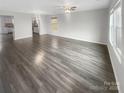 Spacious living room with beautiful wood floors, neutral paint, and plenty of natural light at 9645 Hanberry Blvd # 47, Charlotte, NC 28213