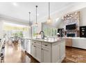 Bright, open kitchen featuring a large island, stainless appliances and modern lighting fixtures at 132 Tuskarora Point Ln, Mooresville, NC 28117