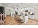 Spacious kitchen featuring a large island with seating, stainless steel appliances, and modern finishes at 13736 Roderick Dr # 171, Huntersville, NC 28078