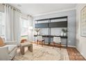 Bright home office featuring two desks with modern shelving and a comfortable sitting area at 13736 Roderick Dr # 171, Huntersville, NC 28078