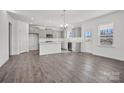 A kitchen with gray cabinets, stainless steel appliances, a white island, and light wood floors at 13744 Roderick Dr # 173, Huntersville, NC 28078