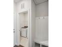 Functional laundry room with washer, dryer, storage, and a convenient bench for added utility at 1418 Windy Park Dr, Stanley, NC 28164