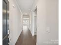 Bright hallway featuring hardwood floors and neutral paint, offering an inviting entrance to the home at 1422 Windy Park Dr, Stanley, NC 28164