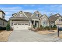 Charming home featuring stone accents, neutral siding, a well-maintained lawn, and an attached two-car garage at 14629 Glen Valley Ct, Charlotte, NC 28278