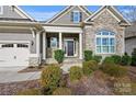 The front entrance features stone pillars, well-maintained landscaping, and a covered entryway, creating curb appeal at 14629 Glen Valley Ct, Charlotte, NC 28278