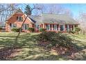 Charming one-story brick home with a manicured lawn and mature landscaping, creating great curb appeal at 212 Glen Eagles W Rd, Statesville, NC 28625