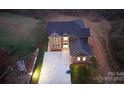 Expansive aerial shot showcasing a brick-and-siding home with a long driveway and natural surroundings at 2302 Rayecliff Ln, Charlotte, NC 28214