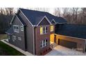 Striking exterior of brick home featuring a two-car garage and manicured lawn, perfect for Gathering living at 2302 Rayecliff Ln, Charlotte, NC 28214