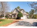 View of home featuring siding and stone accents, gabled roof, a three-car garage, and a well-maintained lawn at 258 Ridge Reserve Dr, Lake Wylie, SC 29710