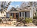 Charming home exterior featuring brick accents, gray siding, and well-maintained landscaping, creating inviting curb appeal at 3428 Braewick Pl, Charlotte, NC 28227