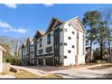 Modern townhouse exterior featuring two-tone color scheme and attached garages at 4207 Walker Rd, Charlotte, NC 28211