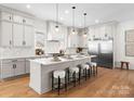Bright kitchen with stainless steel appliances, quartz countertops, and a large island at 4207 Walker Rd, Charlotte, NC 28211