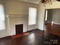 Cozy living room featuring a brick fireplace, hardwood floors, and sun-filled windows at 437 & 437 1/2 Hope St, Rock Hill, SC 29730