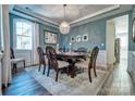 Elegant dining room with a crystal chandelier, dining table set for six, and beautiful wall decor at 5050 Watersail Way, Lake Wylie, SC 29710