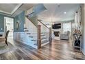 Inviting entryway with hardwood floors, staircase, and views of the living room with fireplace at 5050 Watersail Way, Lake Wylie, SC 29710