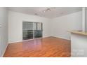 This living room features hardwood floors, light walls, and sliding glass doors to a balcony at 525 N Graham St # 3B, Charlotte, NC 28202