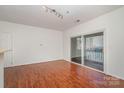 Spacious living room has hardwood floors and sliding glass doors leading to a balcony at 525 N Graham St # 3B, Charlotte, NC 28202