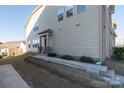 Home exterior featuring a low wall with a front door and walkway at 5337 Orchid Bloom Dr, Indian Land, SC 29707