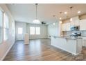Bright, open-concept living space featuring kitchen with island and stainless appliances at 5337 Orchid Bloom Dr, Indian Land, SC 29707