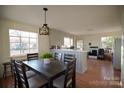 Open dining area with decorative lighting flows into an open kitchen concept at 8405 Fairview Rd, Mint Hill, NC 28227