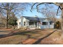 Welcoming single-story home with a ramp, covered porch, and well-maintained lawn at 8405 Fairview Rd, Mint Hill, NC 28227