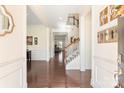 Elegant foyer with hardwood floors, showcasing a staircase and wainscoting, creating a bright and airy entrance at 865 Kathy Dianne Dr, Fort Mill, SC 29707