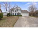 Well-maintained two-story home with blue shutters and an attached two-car garage, perfect for Gathering living at 9413 Pastern Ct, Charlotte, NC 28216