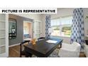 Bright office space with natural light, sleek desk, and views to the outdoors at 122 Woodhall Way, Troutman, NC 28166