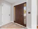 Inviting entryway features neutral tones, and a dark wood front door with sidelights at 1246 Winding Path Rd, Clover, SC 29710