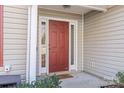 A close-up of the home's front door, painted a deep red and flanked by sidelights at 1246 Winding Path Rd, Clover, SC 29710