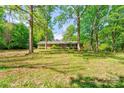 Charming single-story brick home surrounded by mature trees and a well-maintained lawn at 1330 College Ave, Shelby, NC 28152
